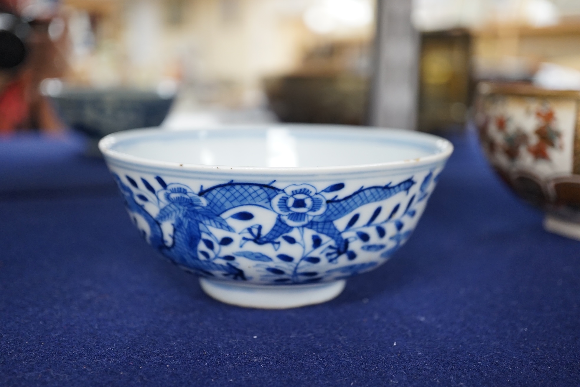 A Chinese blue and white ‘dragon’ bowl, Qianlong mark but 19th century, 12.5cm diameter. Condition - overglazed imperfection